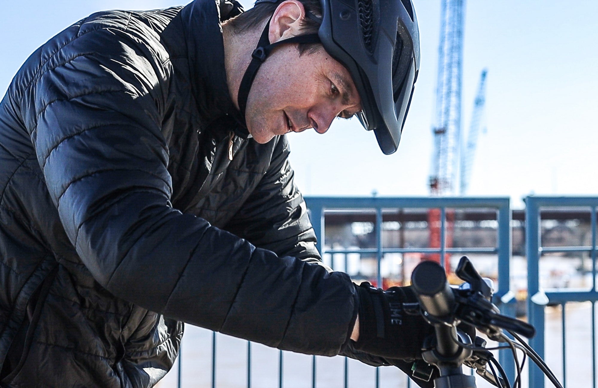 Man tinkers with the display on his Emerald Ebike