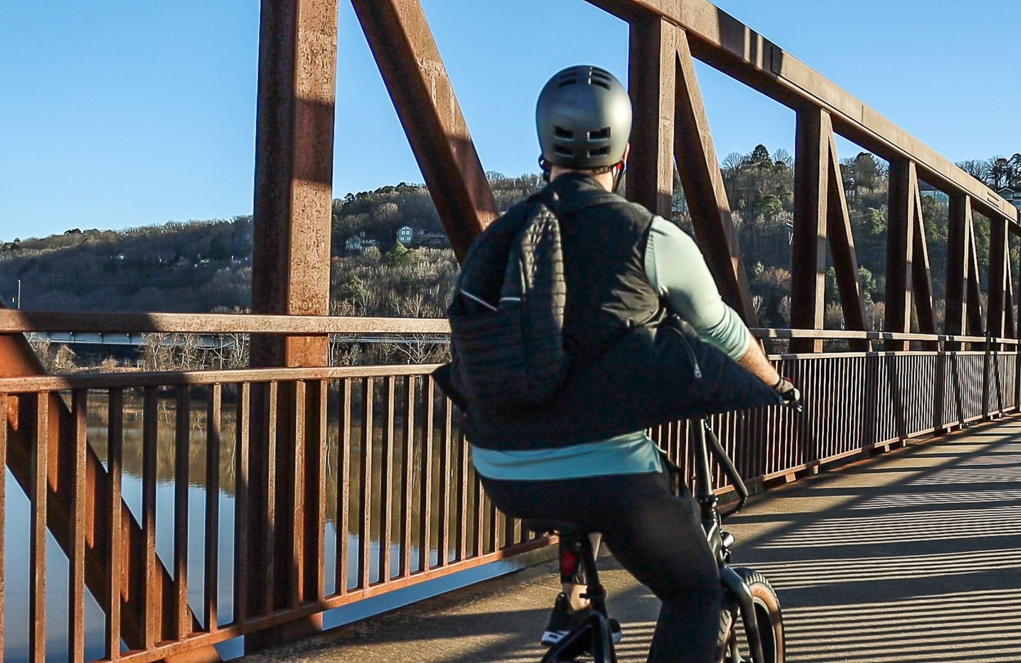 Man riding Emerald Ebike across a bridge for delivery services