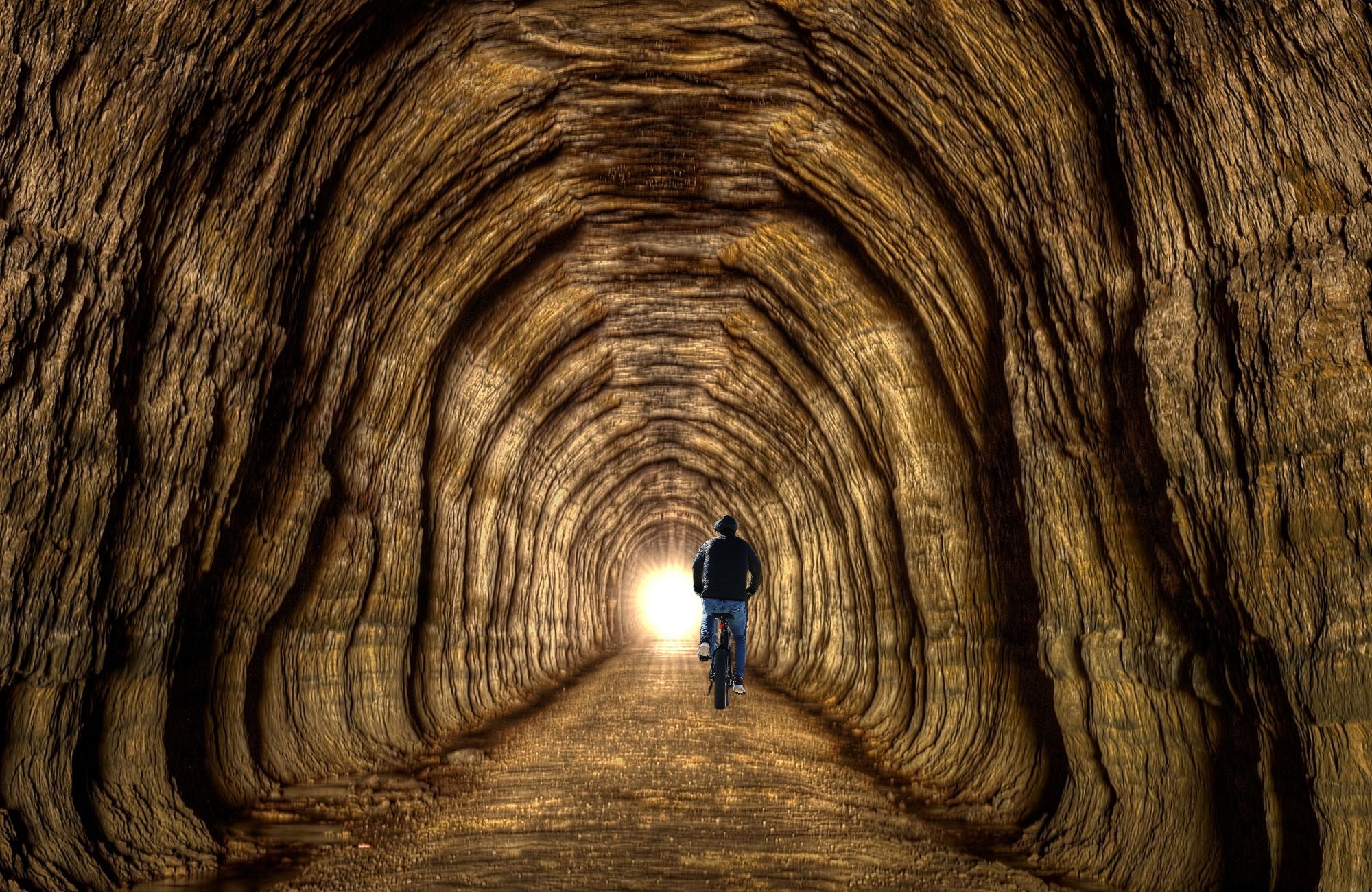 Man riding Emerald ebike through Elroy Sparta Bike Trail Tunnel
