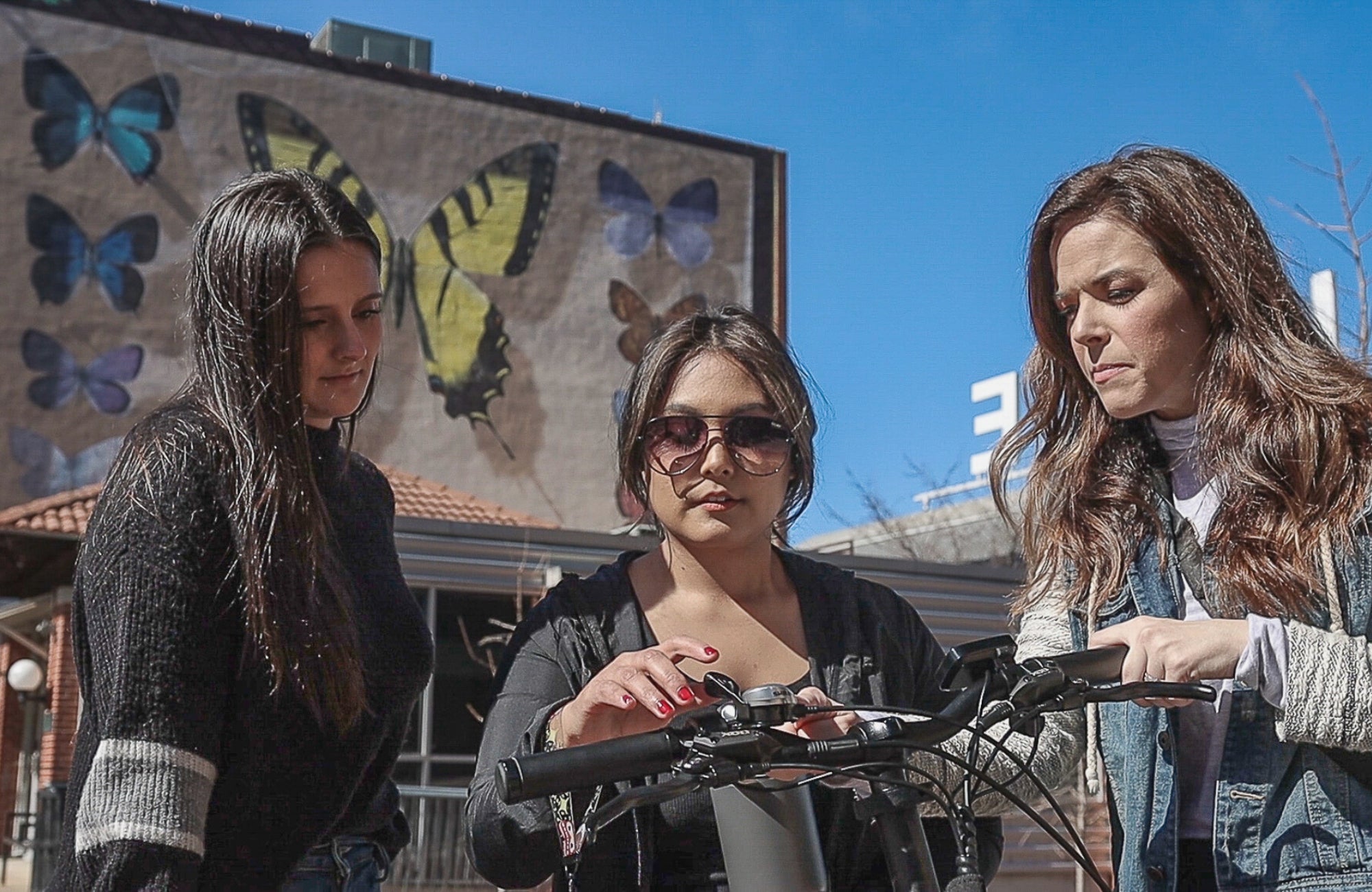 Three woman looking at an Emerald Ebike discussing it