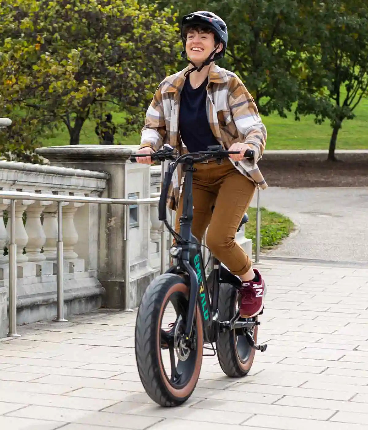 Girl riding ebike on a bridge in the park