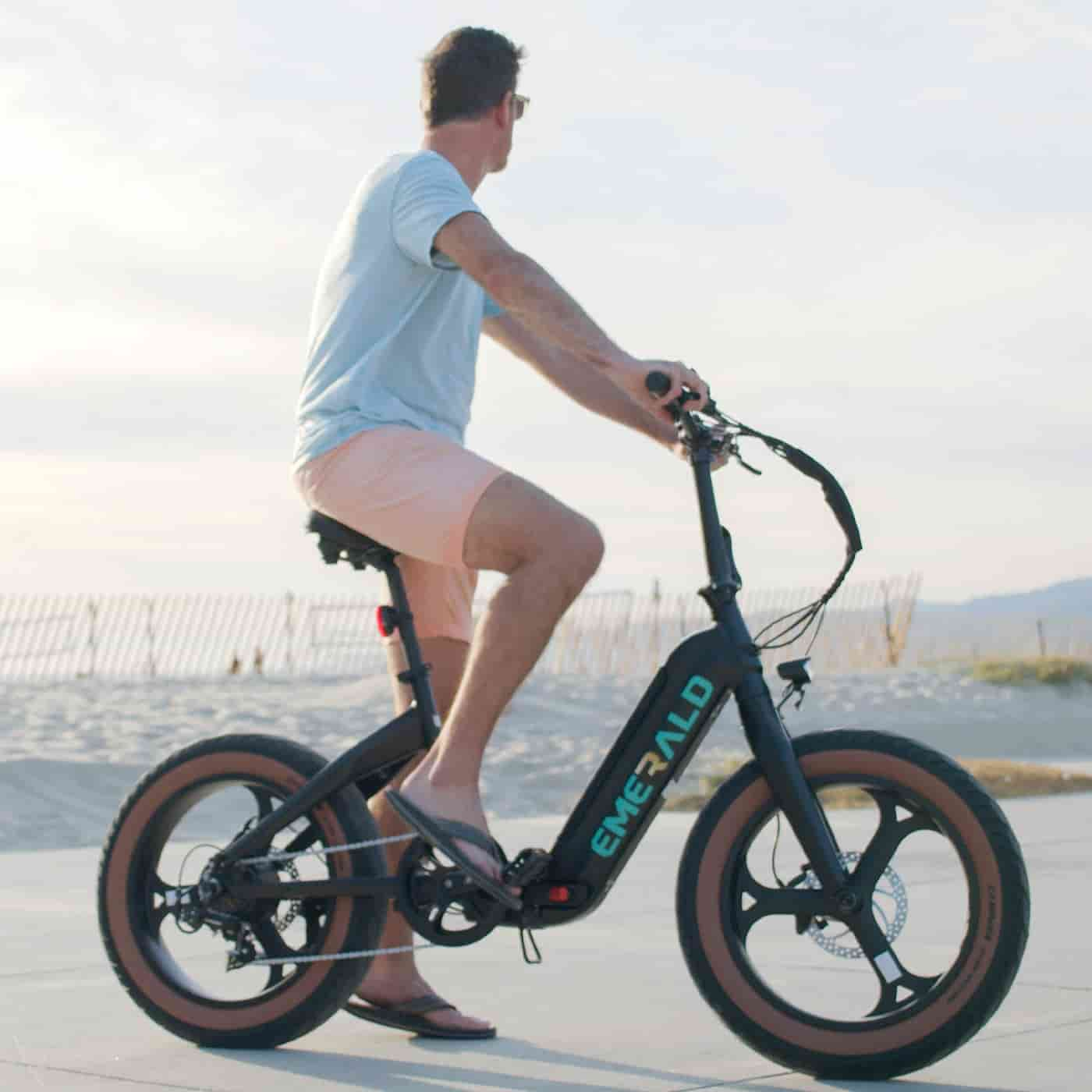 man riding ebike by the beach.