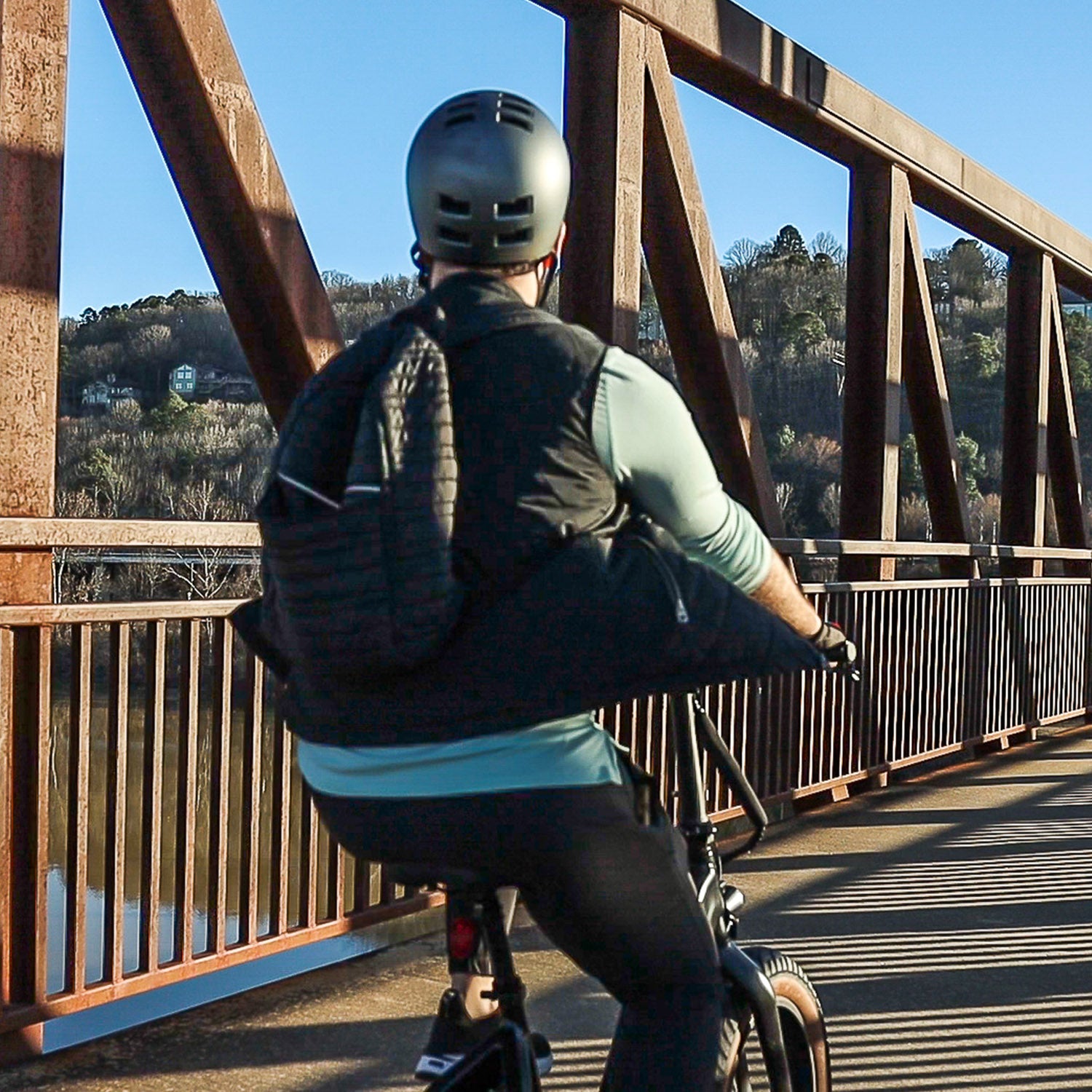 Person riding the Emerald ebike on a bridge.
